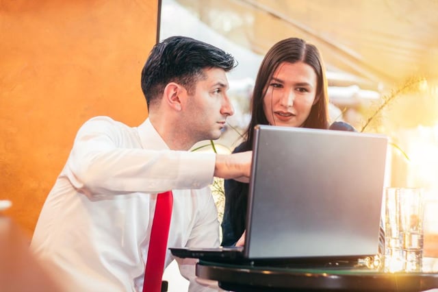 Man showing a woman his computer screen 