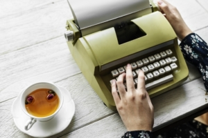 Person typing on a type writer 